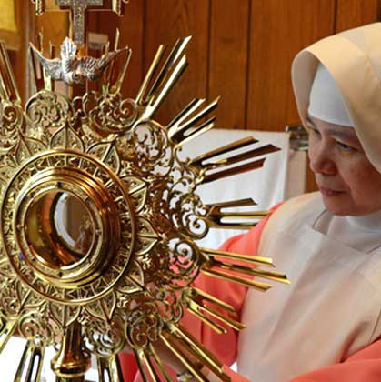pink sister with monstrance
